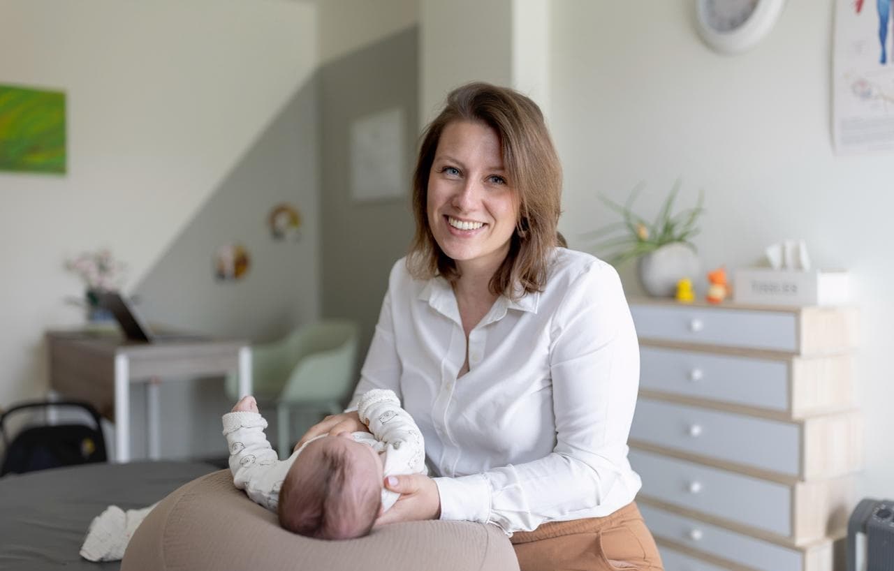 Osteopaat met een baby in de praktijk in Oostende
